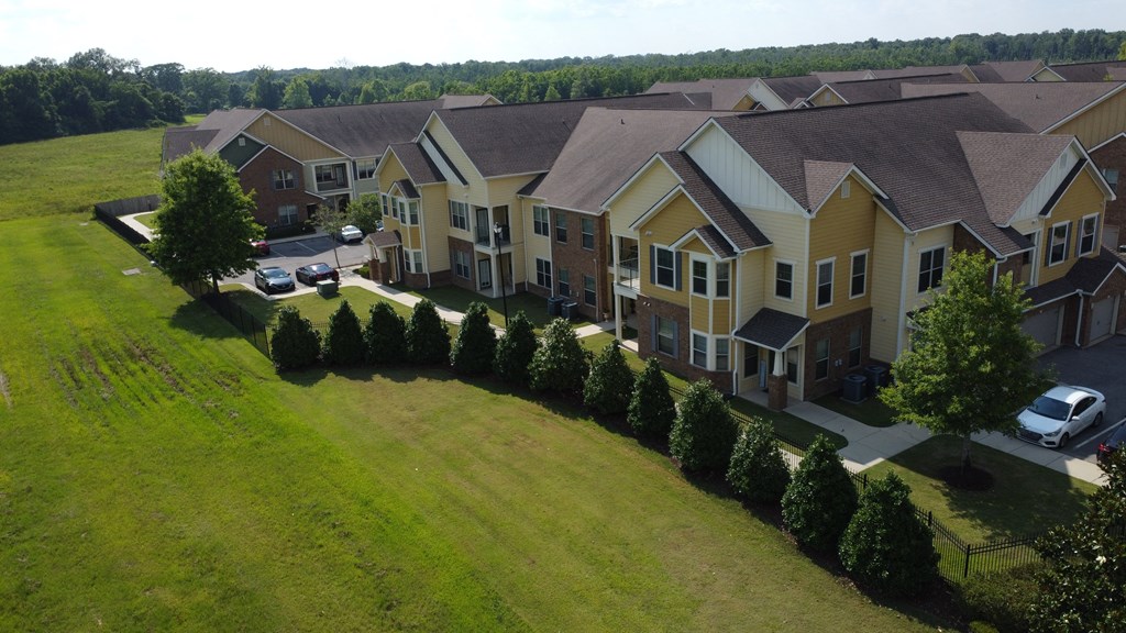 an aerial view of an apartment complex with cars parked in front at Audubon Park Apartment Homes, LA