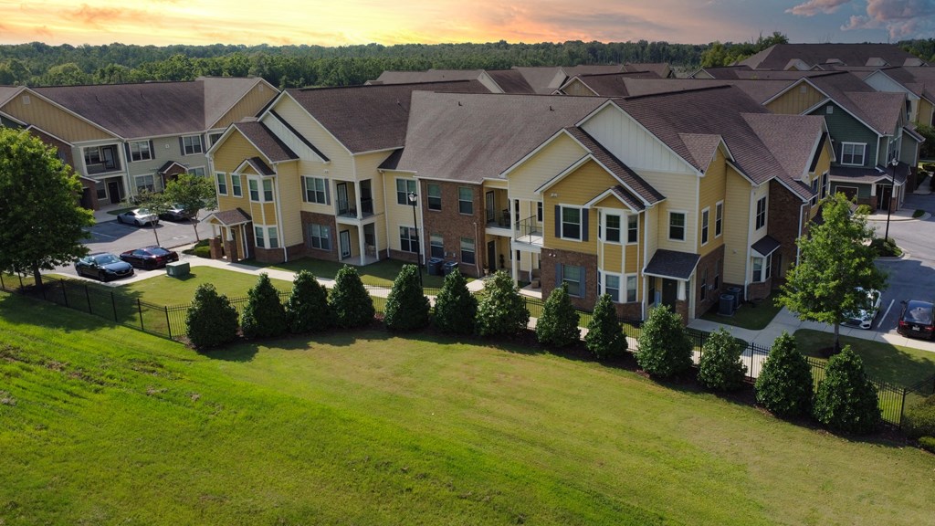 an aerial view of an apartment complex with green grass and trees at Audubon Park Apartment Homes, LA