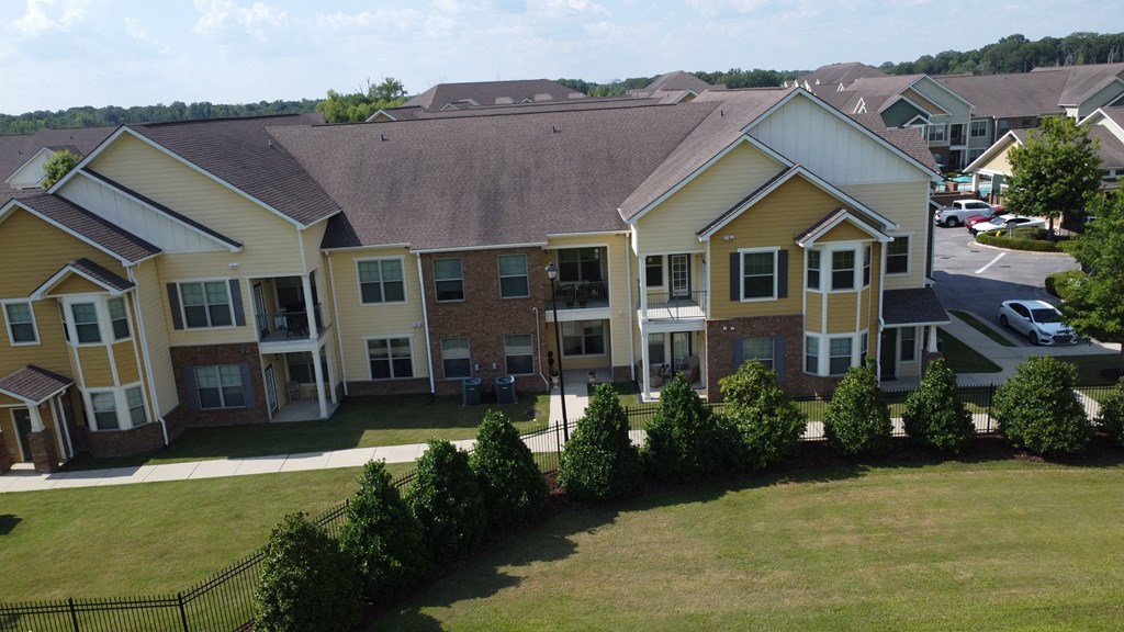 an aerial view of an apartment complex with a lawn and trees at Audubon Park Apartment Homes, Louisiana
