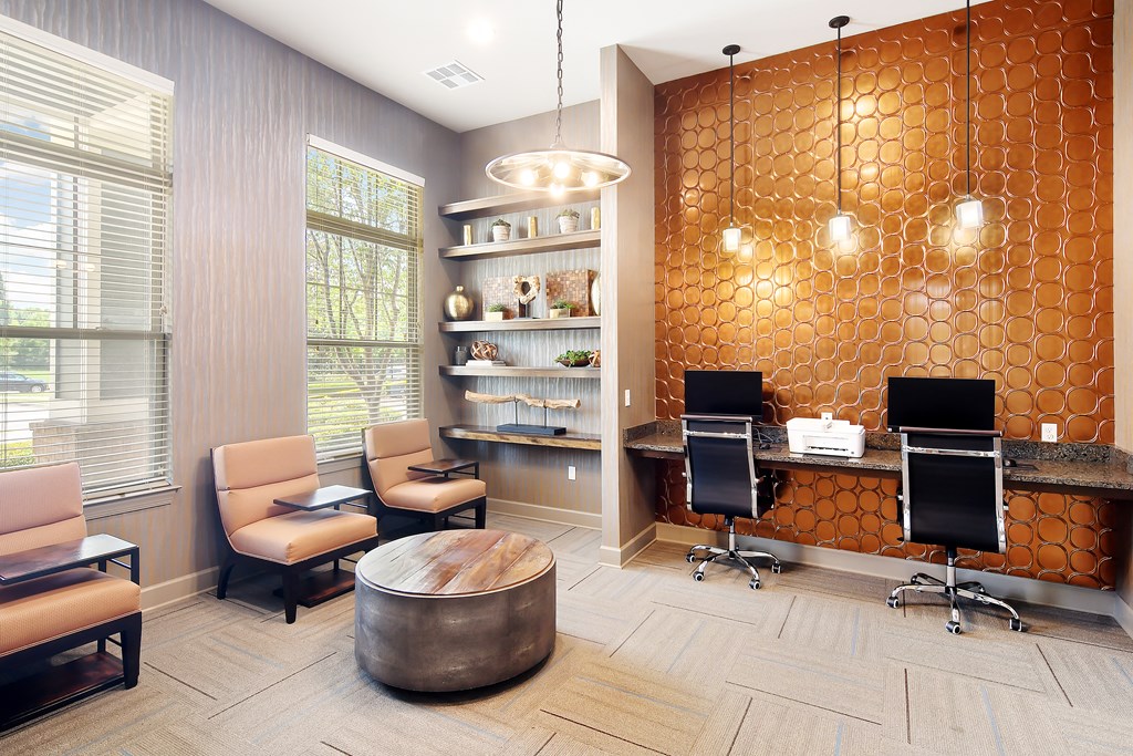 a business center with two desks and chairs and a round table at Audubon Park Apartment Homes, Louisiana