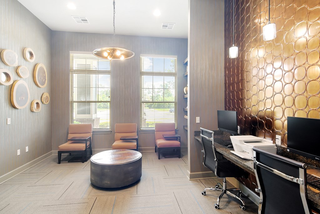 a reception area with a desk and chairs and a window at Audubon Park Apartment Homes, Louisiana