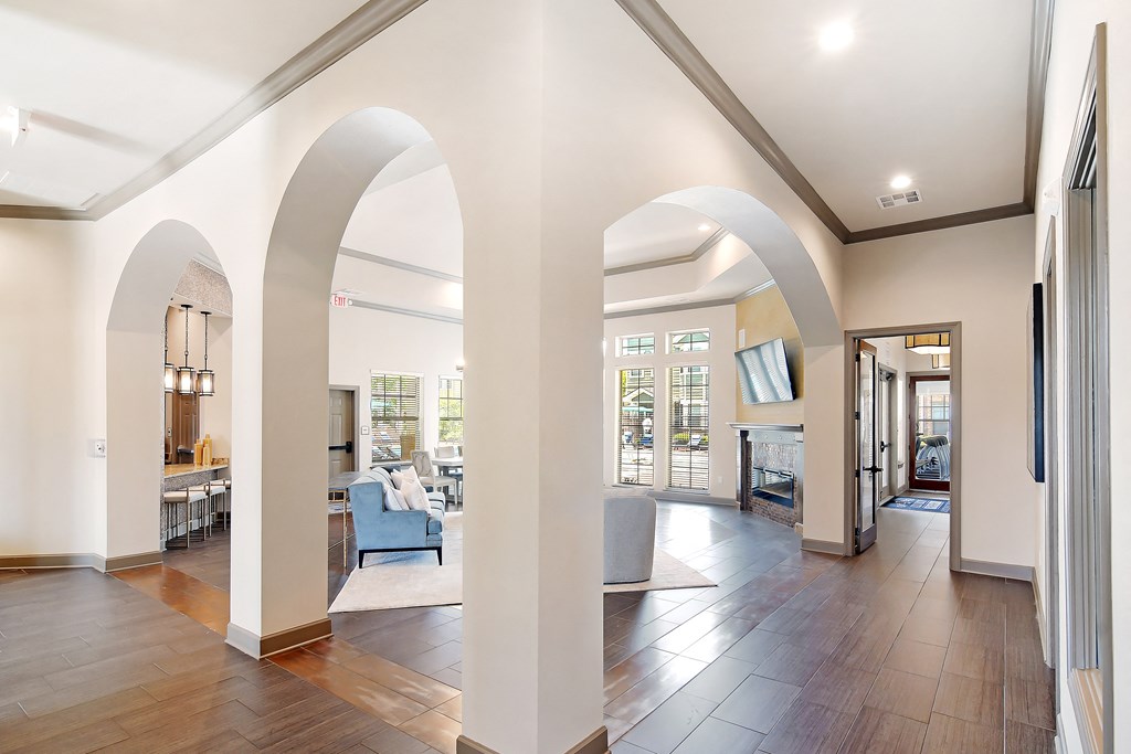 a living room with archways and a large open floor plan at Audubon Park Apartment Homes, LA