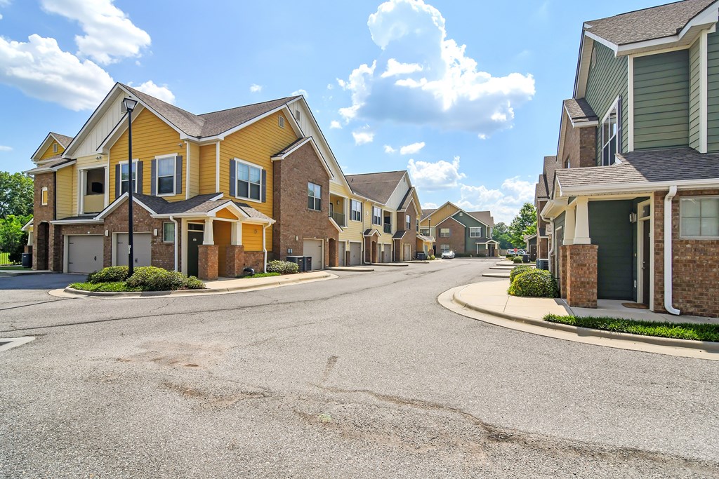 an empty street with a row of houses at Audubon Park Apartment Homes, Louisiana, 70791