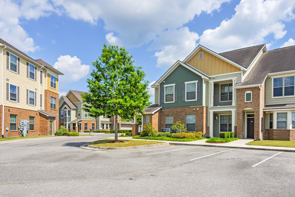 an empty parking lot in front of a row of apartment buildings at Audubon Park Apartment Homes, Zachary, 70791