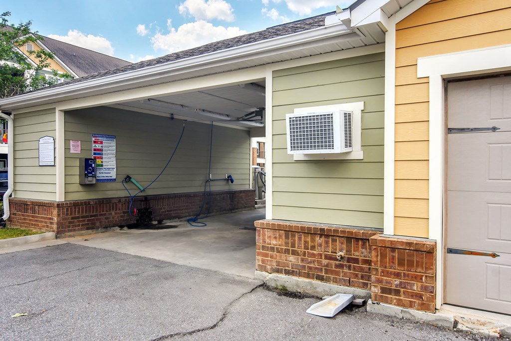 a garage with an air conditioning unit on the side of a house at Audubon Park Apartment Homes, Louisiana