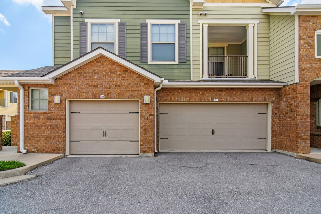two garage doors on the side of a house at Audubon Park Apartment Homes, Zachary, Louisiana, 70791