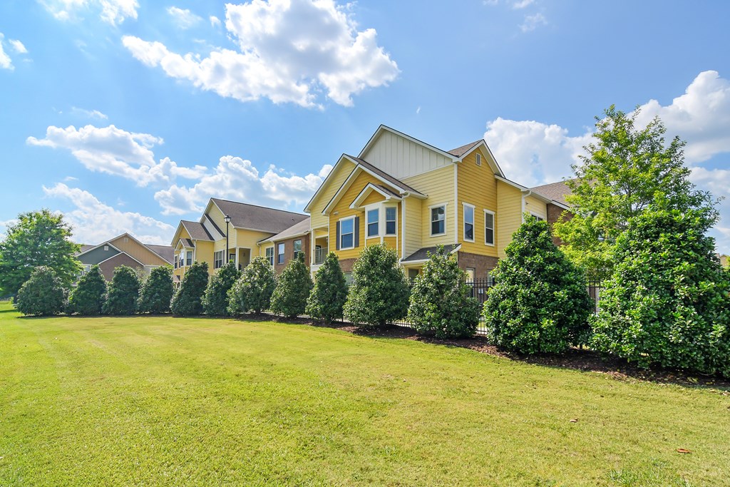 a row of houses with trees in front of them at Audubon Park Apartment Homes, LA