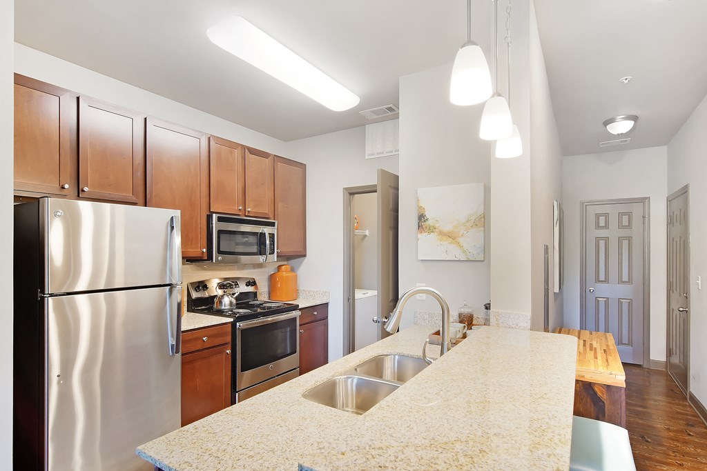 a kitchen with stainless steel appliances and a marble counter top at Audubon Park Apartment Homes, Zachary, 70791