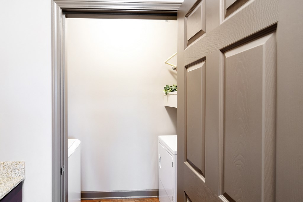 a small laundry room with a closet and a washer and dryer at Audubon Park Apartment Homes, Louisiana, 70791