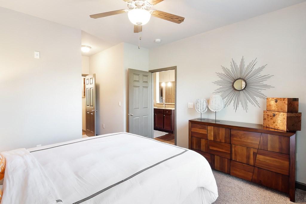 a bedroom with a large white bed and a ceiling fan at Audubon Park Apartment Homes, Louisiana, 70791