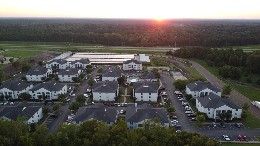 an aerial view of a neighborhood of houses as the sun sets at Avalon Apartment Homes, Starkville, MS