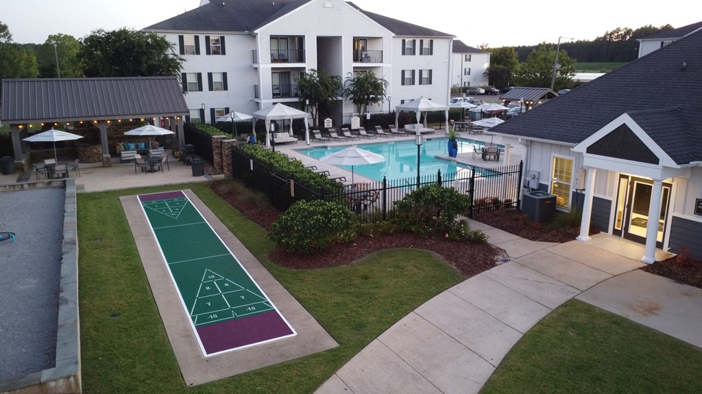 an aerial view of a pool and a basketball court in front of an apartment complex at Avalon Apartment Homes, Starkville, 39759