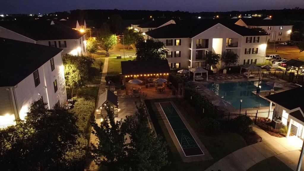 a night view of the resort with a pool at night at Avalon Apartment Homes, Starkville, Mississippi