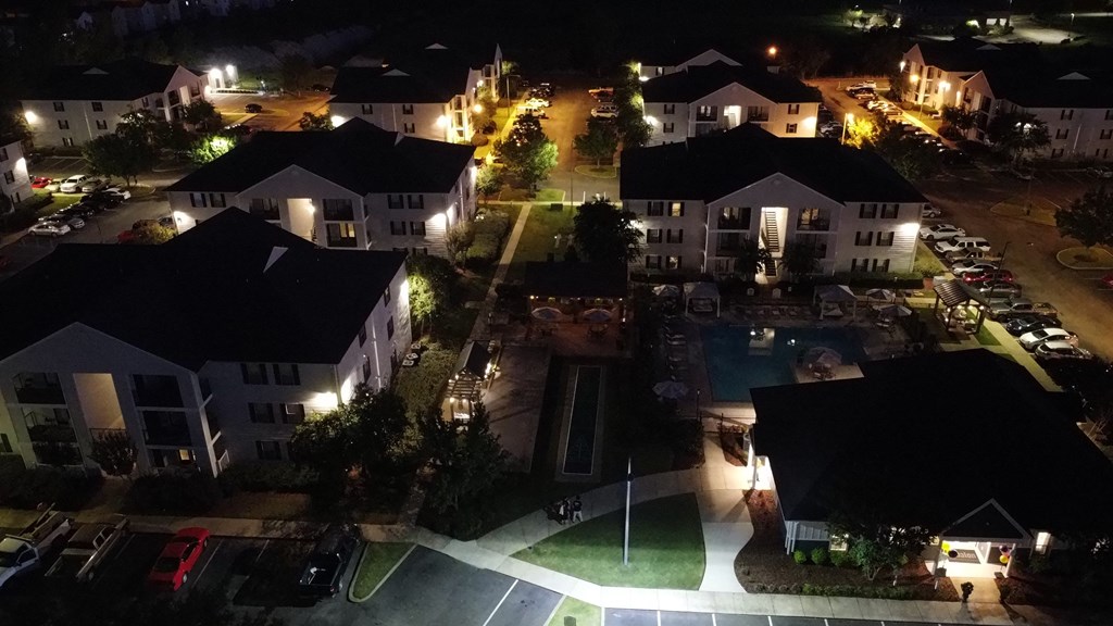 an aerial view of a neighborhood at night with a swimming pool at Avalon Apartment Homes, Starkville, MS, 39759