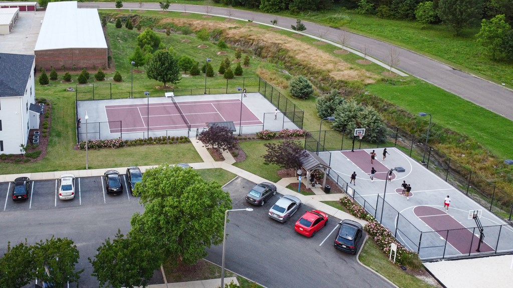 an aerial view of a parking lot with a tennis court at Avalon Apartment Homes, Starkville, MS, 39759