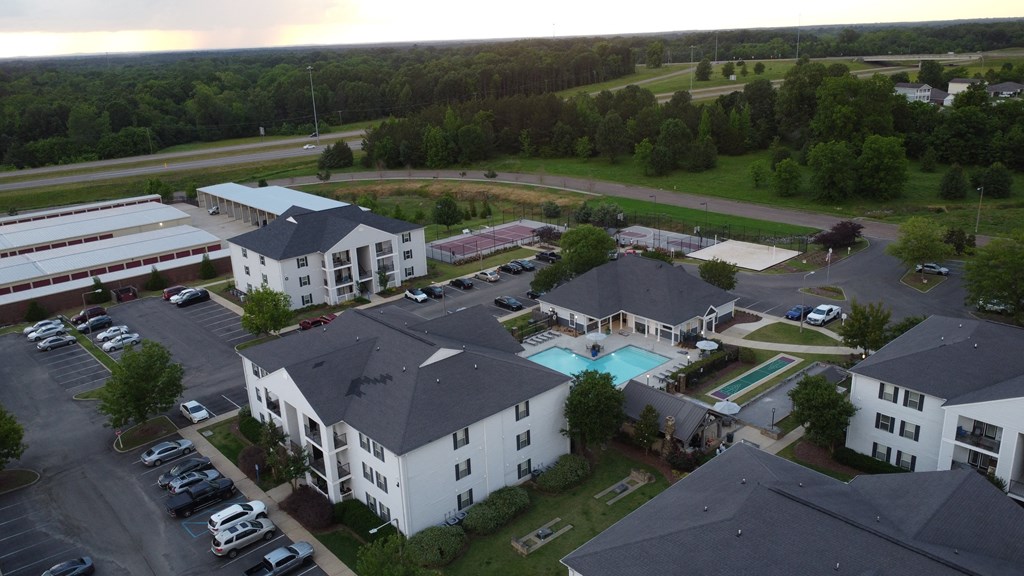 an aerial view of a large building with a pool and parking lot at Avalon Apartment Homes, Starkville, MS, 39759