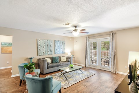 a living room with a couch and a ceiling fan at Avalon Apartment Homes, Starkville, MS, 39759