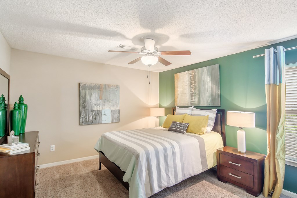 a bedroom with a bed and a ceiling fan at Avalon Apartment Homes, Mississippi, 39759