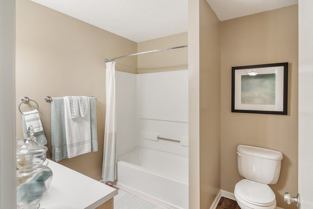 a bathroom with a toilet and a shower and a sink at Avalon Apartment Homes, Starkville, Mississippi, 39759