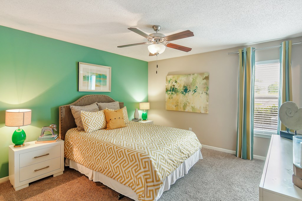 a bedroom with a bed and a ceiling fan at Avalon Apartment Homes, Starkville, Mississippi, 39759