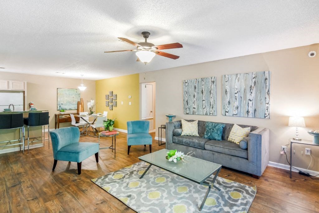 a living room with a couch and a ceiling fan at Avalon Apartment Homes, Mississippi, 39759