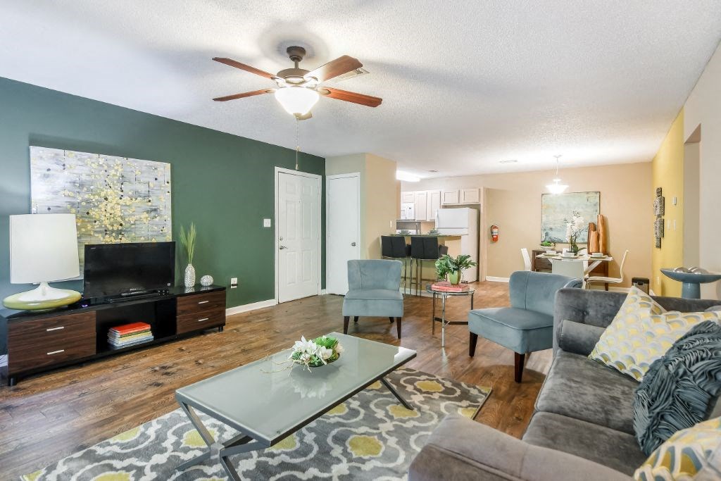 a living room with furniture and a ceiling fan at Avalon Apartment Homes, Starkville, Mississippi