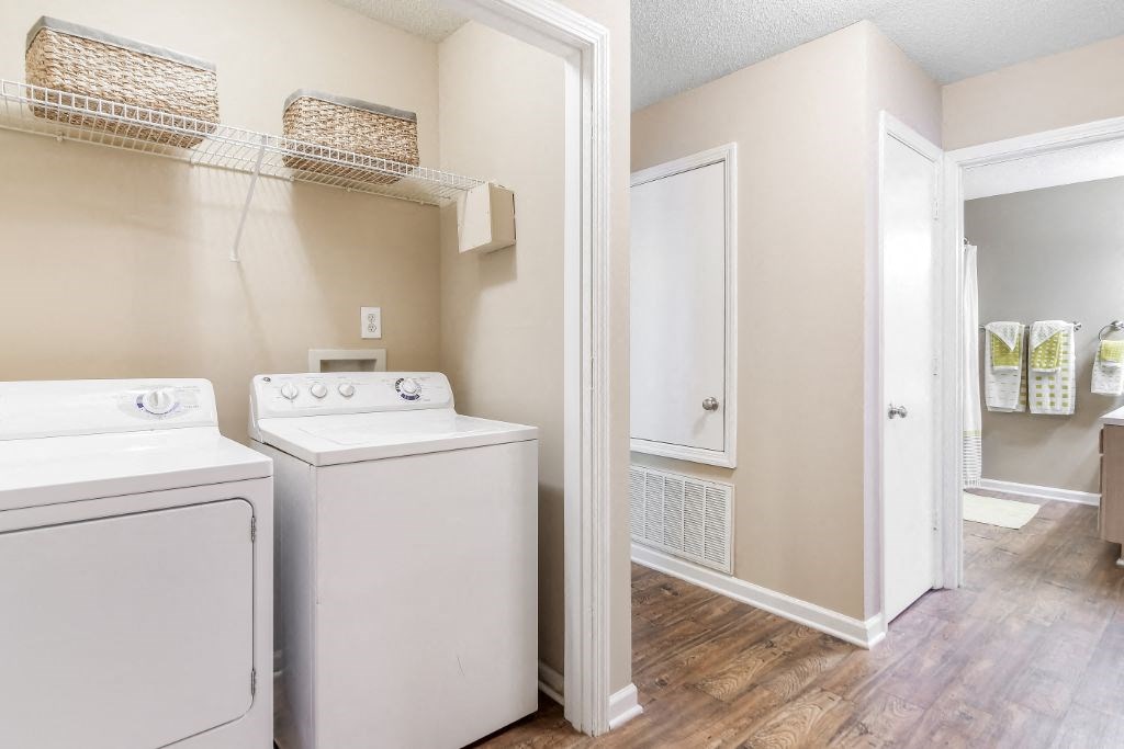a laundry room with a washer and dryer and a closet at Avalon Apartment Homes, Starkville, MS, 39759