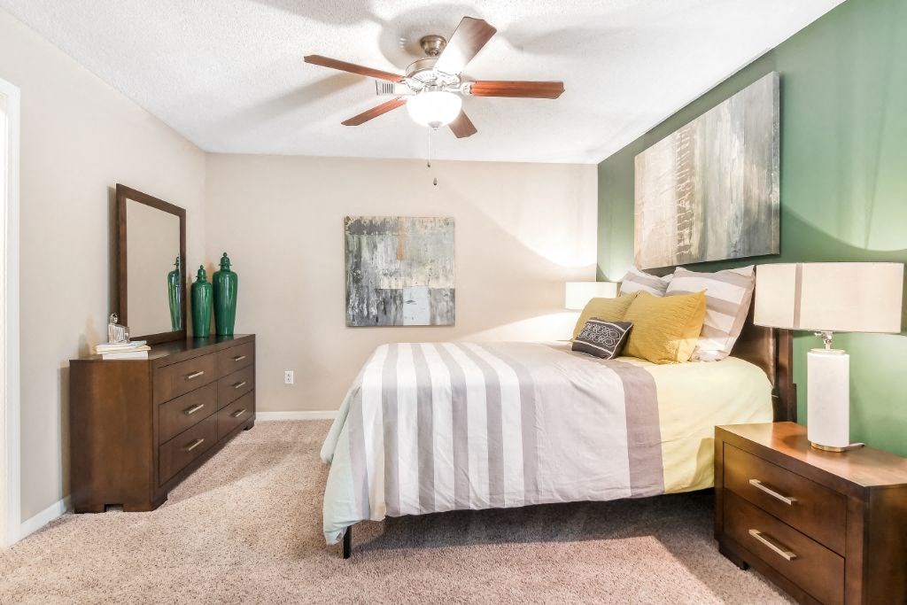 a bedroom with a bed and a ceiling fan at Avalon Apartment Homes, Starkville, MS, 39759