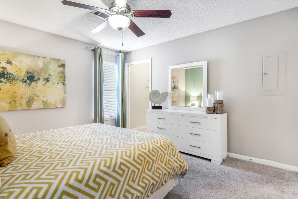 a bedroom with a bed and a ceiling fan at Avalon Apartment Homes, Starkville, MS, 39759