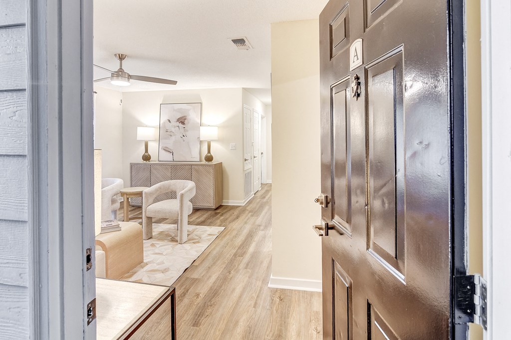 an open door leading to a living room and a dining room at The Oliver Apartment Homes, Olive Branch, MS, 38654