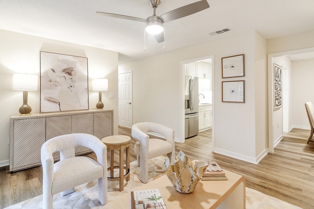 a living room with two chairs and a table at The Oliver Apartment Homes, Olive Branch, MS, 38654