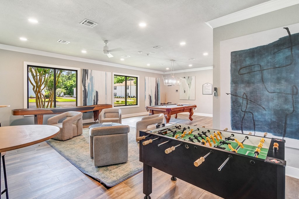 a game room with a foosball table and a pool table
