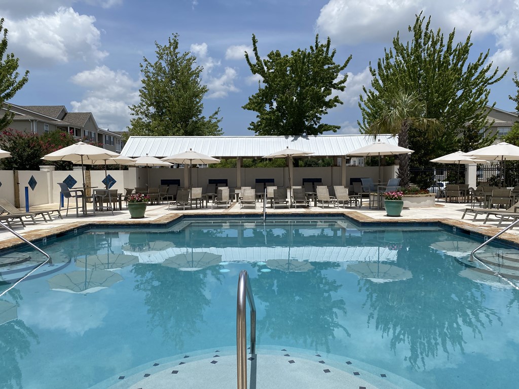 A large swimming pool with a metal ladder in the middle.