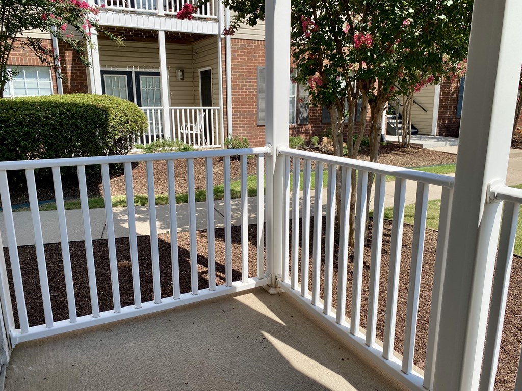 A white railing in front of a house.