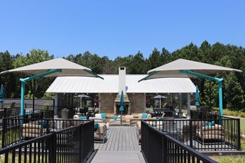 A patio with a white canopy and a black railing at Reserve at Park Place Apartments, Hattiesburg, 39402