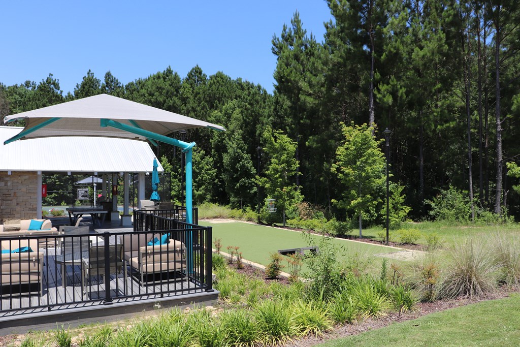 a patio with a gazebo overlooking a golf course and trees at Reserve at Park Place Apartments, Hattiesburg, 39402