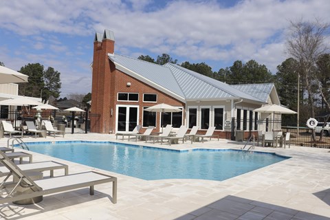 A pool with a building behind it.