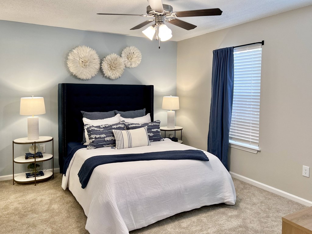 a bedroom with a bed and a ceiling fan at Reserve at Park Place Apartments, Hattiesburg