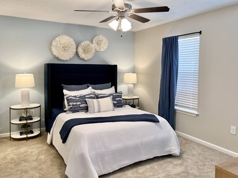 a bedroom with a bed and a ceiling fan at Reserve at Park Place Apartments, Hattiesburg