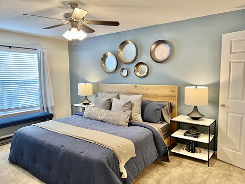a bedroom with a bed and a ceiling fan at Reserve at Park Place Apartments, Hattiesburg, MS