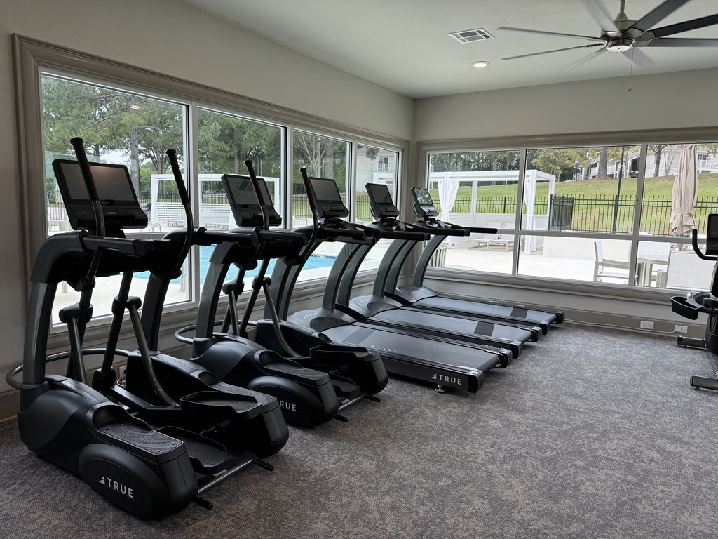 a gym with cardio machines and a large window at Laurelwood Apartment Homes, Laurel, Mississippi, 39440