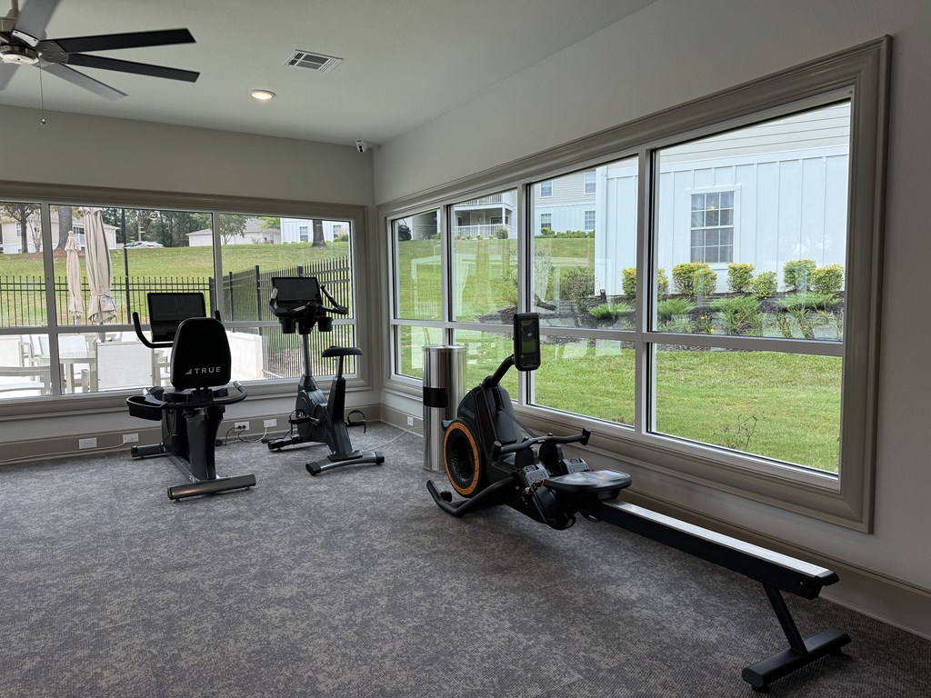 a home gym with exercise equipment and large windows at Laurelwood Apartment Homes, 39440