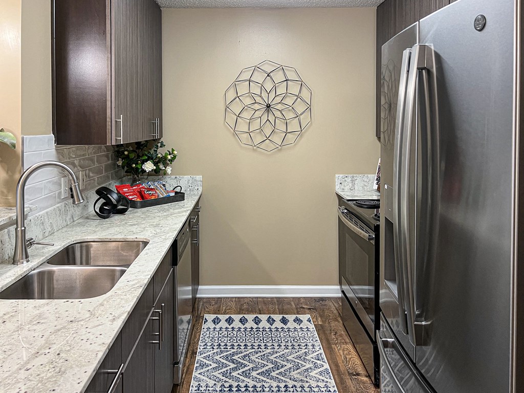 a kitchen with stainless steel appliances and granite counter tops at Reserve of Bossier City Apartment Homes in Louisiana 71111