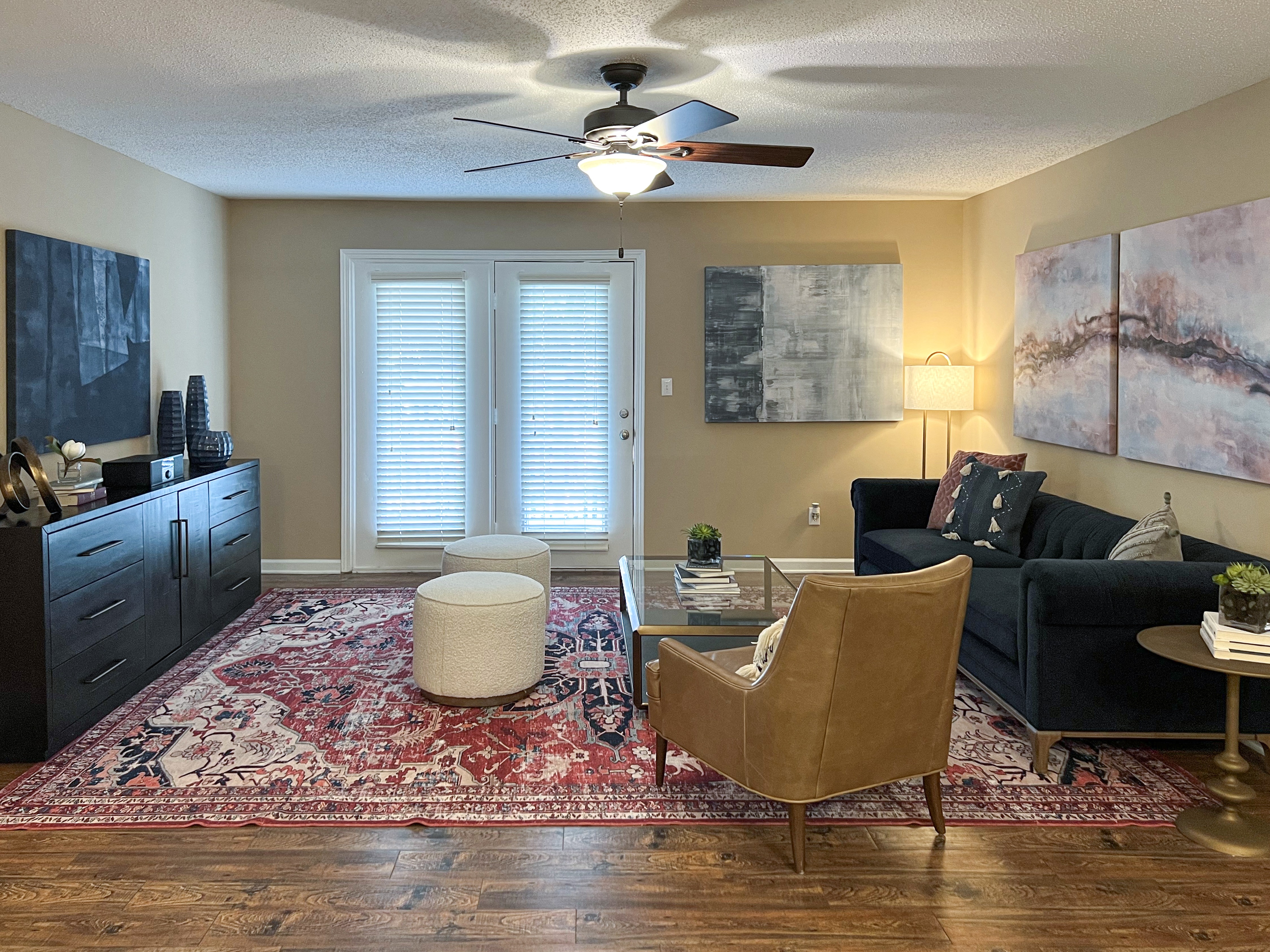 a living room with furniture and a ceiling fan