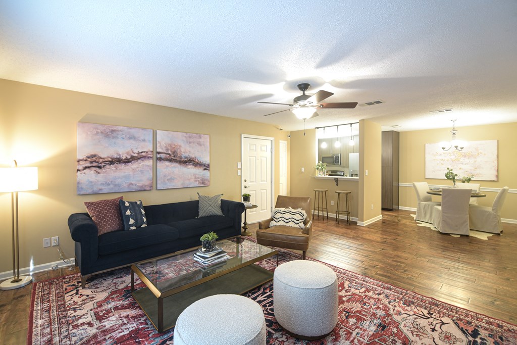 a living room with a couch and a ceiling fan at Reserve of Bossier City Apartment Homes in Bossier City, Louisiana