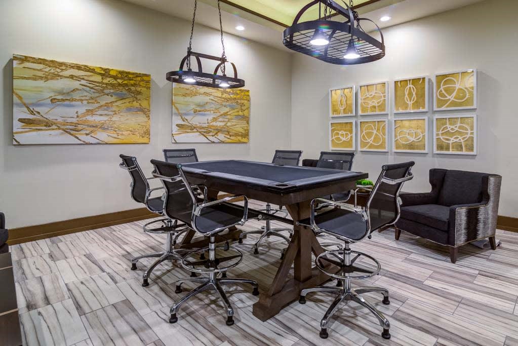 a conference room with a table and chairs at The Retreat Apartment Homes in Williston, North Dakota