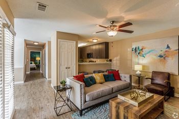A living room with a couch, a chair, and a coffee table  at Quail Ridge Apartment Homes, Bartlett, 38135