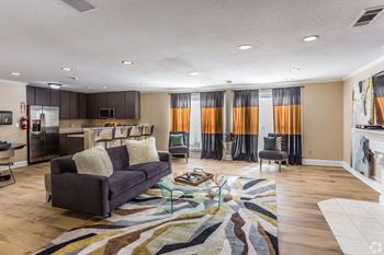 A living room with a grey couch and a glass coffee table at Quail Ridge Apartment Homes, Bartlett, 38135