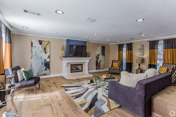 Clubhouse with a fireplace and grey couch  at Quail Ridge Apartment Homes, Bartlett, 38135