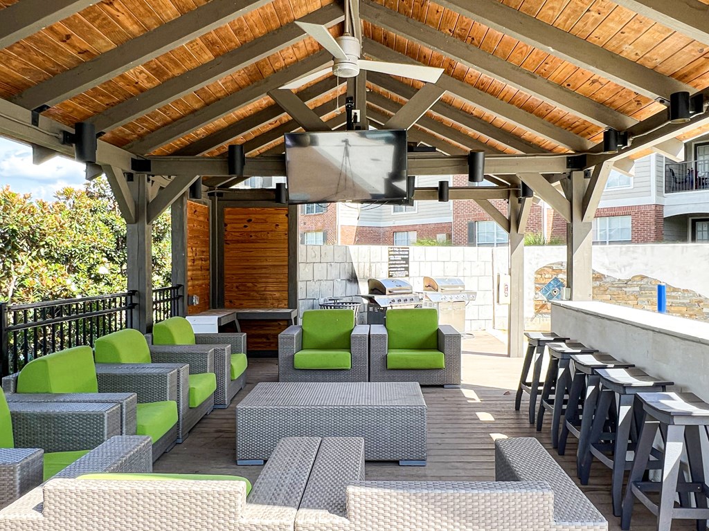 a patio with chairs and tables and a bar at Quail Ridge Apartment Homes, Tennessee, 38135